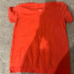 orange/red lululemon swiftly tech shirt—-never worn!!